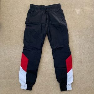 H&M black track pants with red and white accents